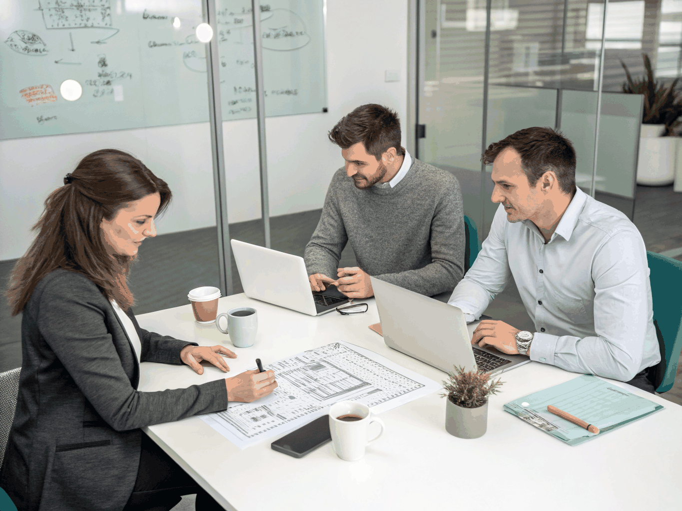 Senior engineering consultants reviewing FinTech software architecture topologies